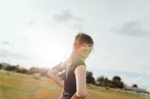 Fitness female on field in morning