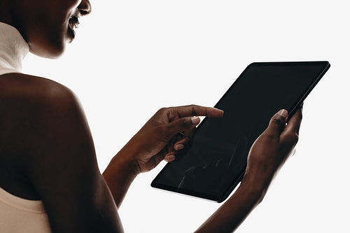 Woman using a tablet device on a white isolated background