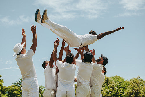 Cricket players celebrating the man of the match