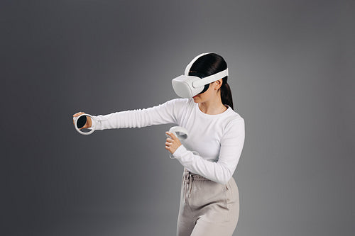 Young woman gaming in the metaverse