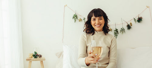Woman enjoying wine during christmas celebration