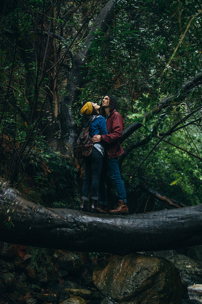 Couple in love getting wet in rain at forest