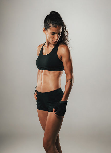 Pretty woman poses in her athletic shorts and top