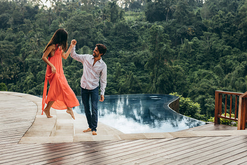 Young couple near pool at resort