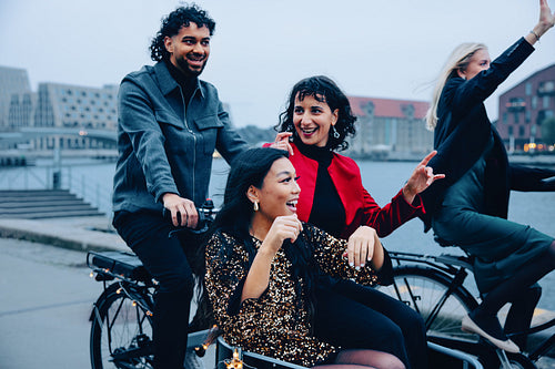 Group of friends enjoying a night ride near the waterfront