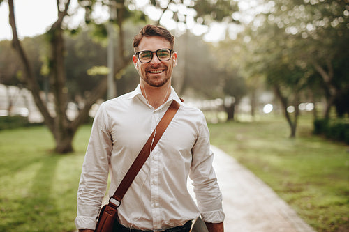 Smiling businessman walking to office