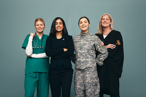 Cheerful female professionals standing in a studio