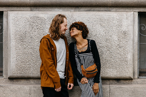 Affectionate couple sharing a tender moment on urban backdrop