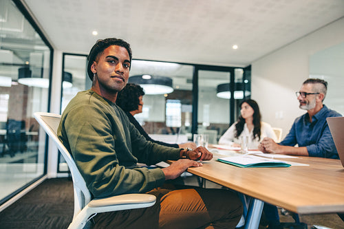 Young businessman sitting in a briefing in a boardroom