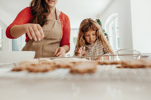 Woman and girl making Christmas cookies