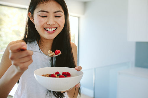 Smiling woman having nutritious breakfast