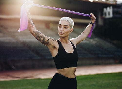 Fitness woman doing workout standing in a stadium