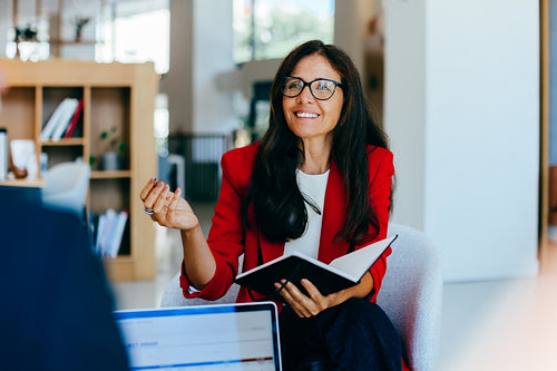 Senior businesswoman discussing ideas during a meeting in a corporate setting