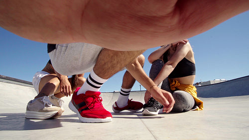 Three friends taking a group selfie in a skate park