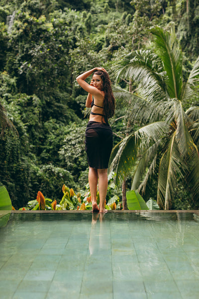 Beautiful bikini model posing at poolside