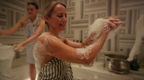 Women Enjoy a Joyful and Luxurious Foam Bath at a Traditional Turkish Hammam Spa