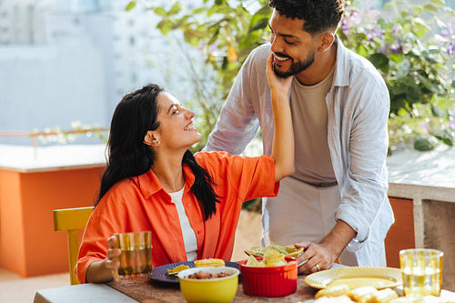 Couple enjoying a meal together on a vibrant outdoor terrace
