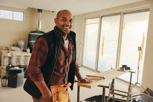 Mature man standing in his home kitchen, ready for DIY renovation work