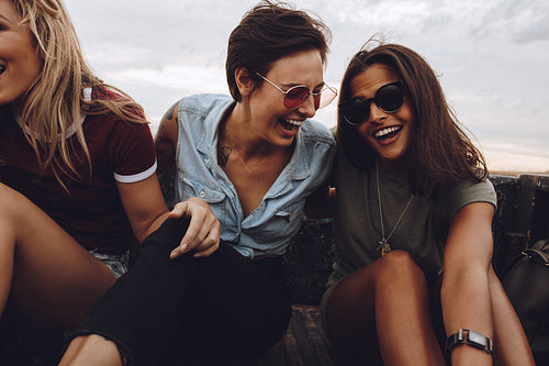 Women enjoying a country road ride in a pickup truck.