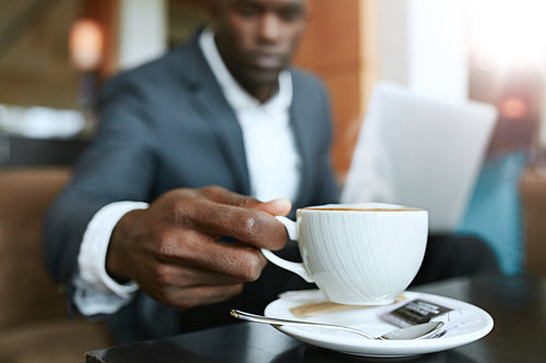 Businessman at hotel lobby drinking coffee