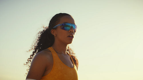 African-American athlete fixes her hair before volleyball serve