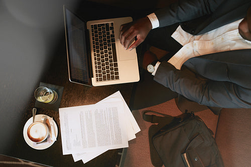 Businessman at coffee shop working on laptop