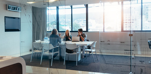 Three designers discussing in meeting hall
