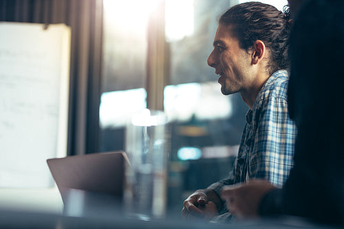 Happy man sitting in business meeting