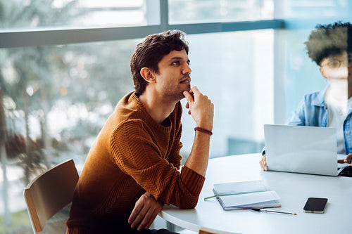 Man in thoughtful moment during business meeting