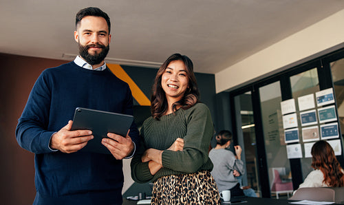 Cheerful business colleagues smiling at the camera happily