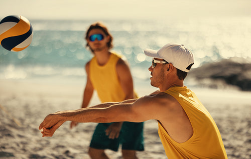 Brazilian male volleyball team enjoying a coastal tournament on a sunny summer day