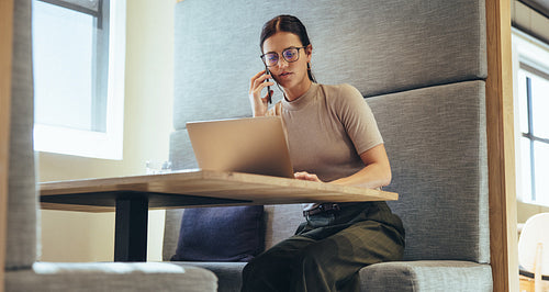 Entrepreneur speaking on the phone in a modern workspace