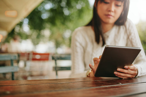 Woman using tablet at coffee shop