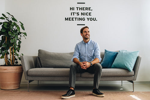 Entrepreneur sitting in lobby and looking away