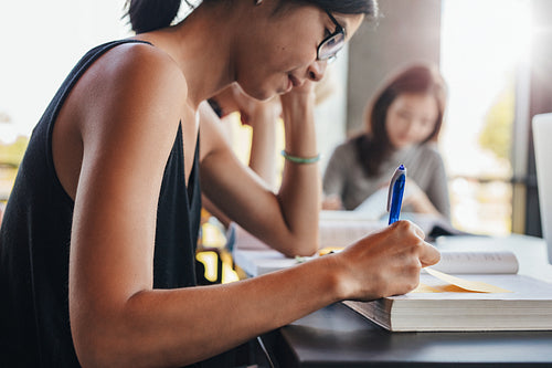 Young students studying in university library