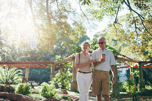 Couple of tourist walking through a park
