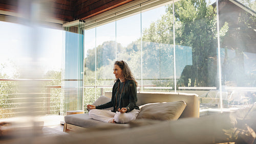 Holistic healer meditating on a couch