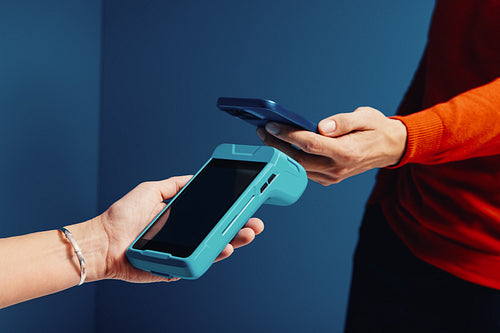 Customer using smartphone for an electronic payment transaction