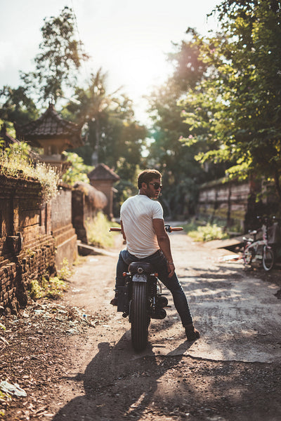 Young man sitting on his motorcycle