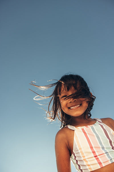 Happy young girl having a good time at the beach