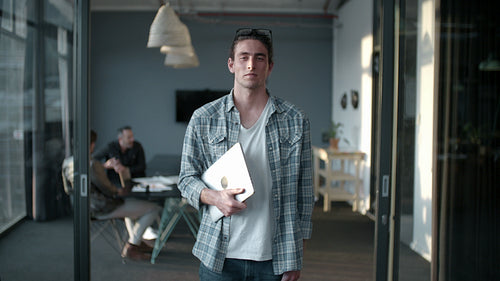 Smiling business man in casuals at office.