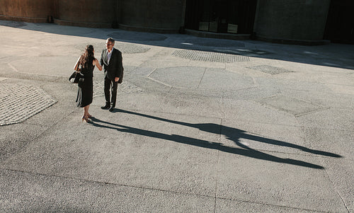 Aerial view of business people meeting and shaking hands outdoors