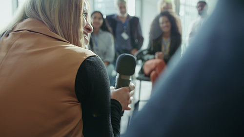 Woman speaking with microphone at conference