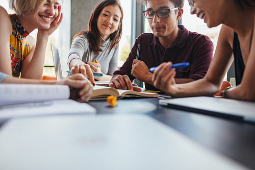 Young students collaborating on project in library