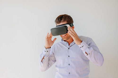 Happy businessman watches content on a virtual reality display