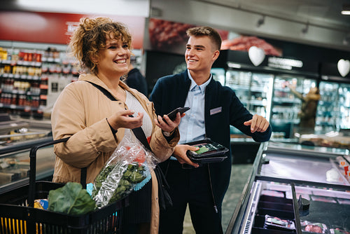 Happy woman customer shopping in supermarket