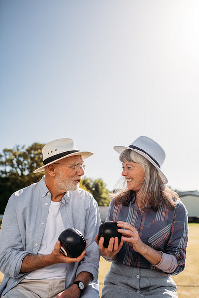 Senior couple sitting together outdoors and talking