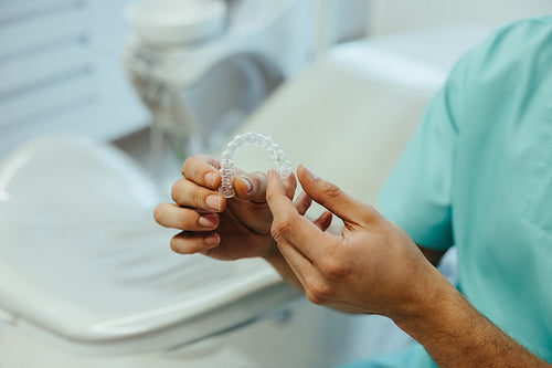 Close-up of clear dental aligner in clinic setting