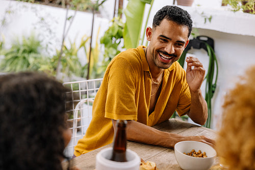 Man enjoying a casual conversation with friends in an outdoor setting