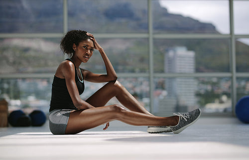 Woman resting after intense training at fitness studio